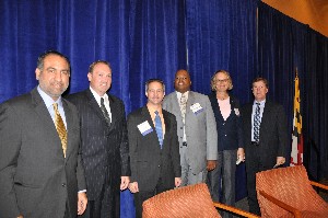 Speaking at the chapter's October breakfast meeting are (l-r) James Washington, Federal Aviation Administration; Robert Coen, National Institutes of Health Information Technology Acquisition and Assessment Center; Steve Krauss, chapter president; Herbert Jackson Jr., U.S. Government Printing Office; Joanne Woytek, NASA; and Michael O'Neill, General Services Administration.